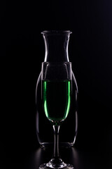 wine glasses and bottles with liquids marking their silhouette with light and black background