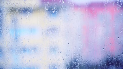 Fototapeta premium Close up view of water drops falling on glass. Rain running down on window. Rainy season, autumn. Raindrops trickle down, grey sky. Great for special effects and motion graphics.