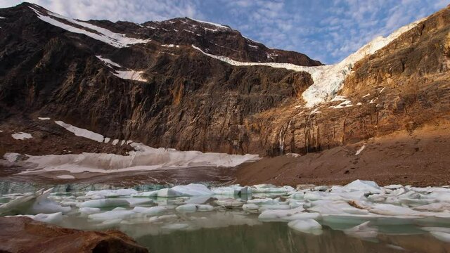 Time Lapse Shot Of Frozen Ice Floating In Lake By Mountains During Winter - Jasper, Canada