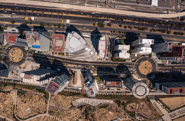 Birds eye view of rooftop of building and skyscrapers with empty street and road in Santa Fe which...