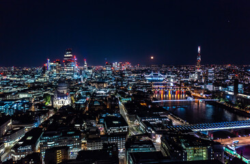 Beautiful night view of London city with illuminated lights from building and streets under black sky