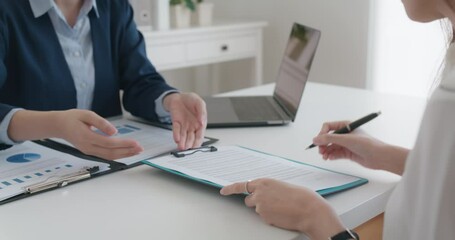 Close-up hand asia people woman fill rent loan form write legal debt letter at lawyer home office. Happy female life buy or sell new house deal from real estate sale agent. Tax advice talk and smile.