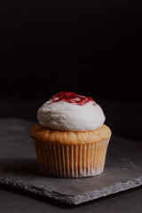 Red fruit cupcake on dark table