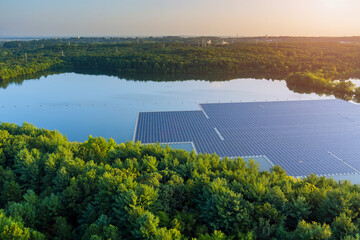 Aerial view of lake in renewable alternative electricity on floating solar panels platform