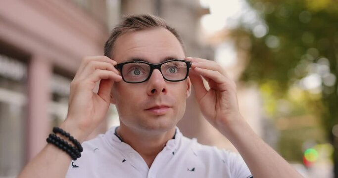 Man squint because have myopia wearing eyeglasses for good vision