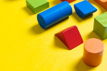 Multiple colorful geometric shapes on yellow background for design element