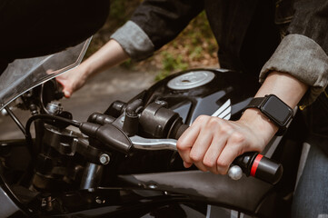 Close up of motorcycle rider hand holding clutch. A motorcycle clutch is a mechanical device that...