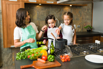 Mother and children cooking dinner