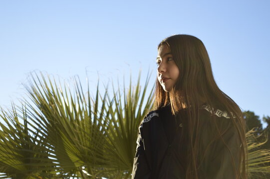 Portrait of young teenager on palm beach.