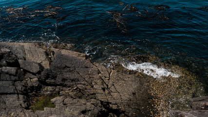 Waves crashing on a rocky shore in the ocean.