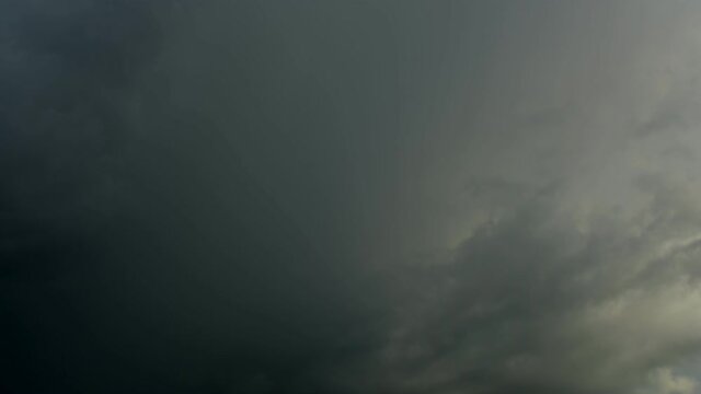 4K Time lapse, Gray and white rolling puffy clouds floating in the sky.