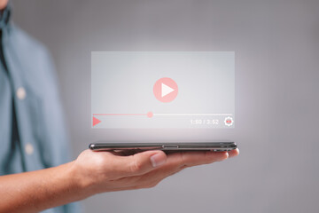 Hand holding mobile phone for live video content online streaming marketing concept.