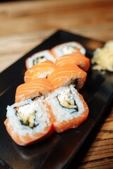 Philadelphia Maki Sushi made of Philadelphia Cream Cheese inside, Fresh Raw Salmon outside. Garnished with Sauce