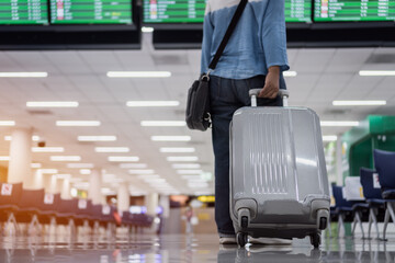 Flight Cancelled on COVID-19 virus disease concept, Asian traveler senior hold luggage at terminal...