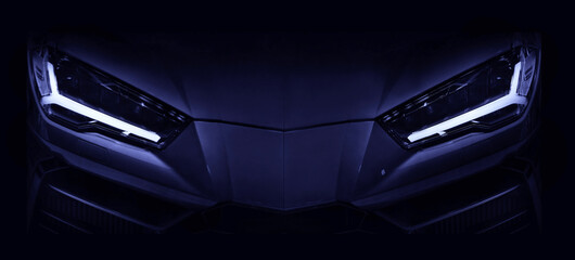 Obraz na płótnie Canvas Silhouette of black sports car with LED headlights on black background