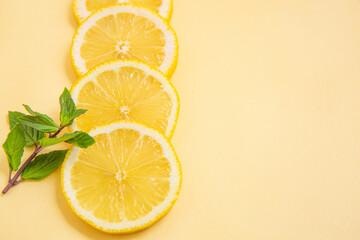 sliced lemons on yellow background