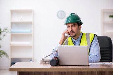 Young male architect working in the office