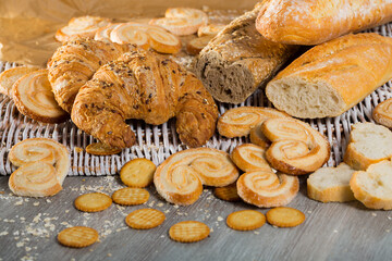 Fototapeta na wymiar Assortment of fresh bread and bakery products lying on table .