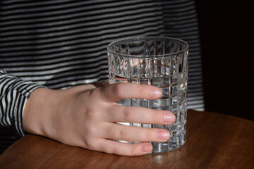 Close up of a young girl holding a glass of water