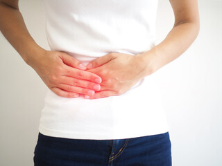 Woman suffering abdominal pain on the side due to salpingitis. closeup photo, blurred.