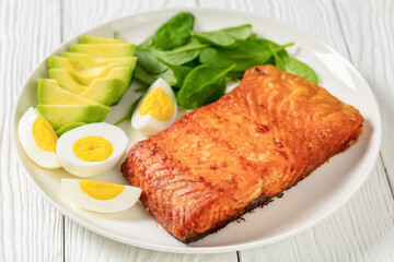 baked salmon fillet with eggs , spinach, avocado