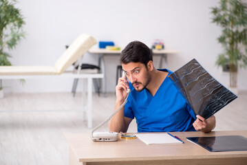 Young male doctor radiologist sitting in the clinic