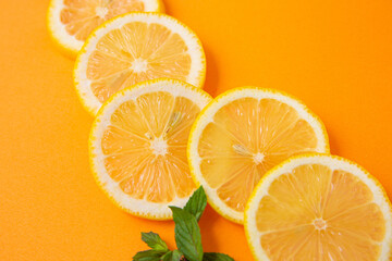sliced lemons on orange background