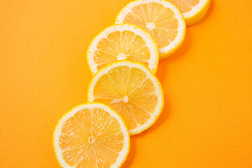 sliced lemons on orange background