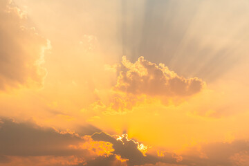 The image of the golden sky in the evening before sunset. with clouds obscuring the sun