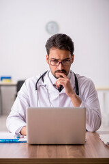 Young male doctor in telemedicine concept