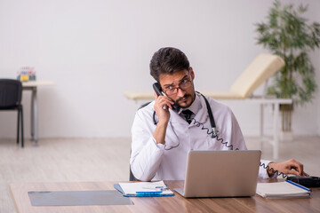 Young male doctor in telemedicine concept