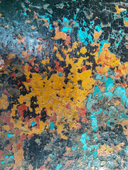 The texture of peeling old rusty red-blue-yellow metal. Natural scenic metal background.