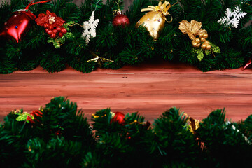 Christmas and new year decoration border put on natural wood board wide copy space at the  middle. Festive ornaments with pine tree branches and artificial music instrument