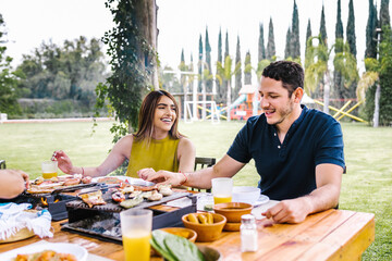 hispanic couple eating tacos and mexican food at outdoor Restaurant terrace in Mexico Latin America