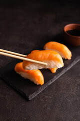 Philadelphia sushi on a black plate