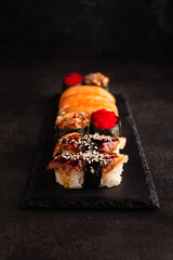 Japanese food, sushi on a black plate, top view