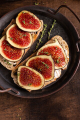 Sweet bruschetta with cream cheese and figs for breakfast