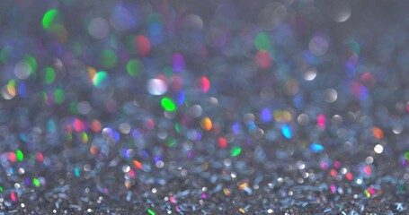 Magic festive shiny background for Christmas. Neon pastel bright magic unicorn rainbow abstract lights. Blurred colorful light dots. Dust or flying particles