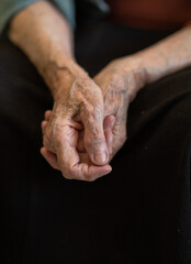 Grandmother's hands are wrinkled, the old hands of a pensioner, veins in the skin, old age in a woman.

