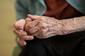 Grandmother's hands are wrinkled, the old hands of a pensioner, veins in the skin, old age in a woman.
