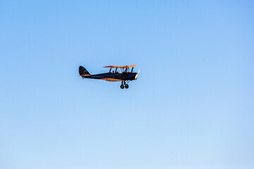Old Tiger moth plane flying in the sky