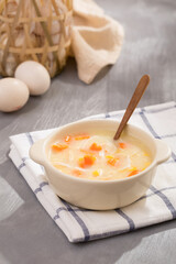 Porridge vegetable and egg on grey background