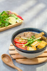 The crab noodle soup or another name Bun Da Cua, is a traditional Vietnamese. The signature ingredient is the reddish brown noodle, herb, tomato, tofu. 