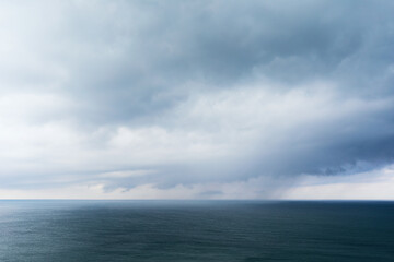 Fototapeta premium Background with rain clouds on the sea
