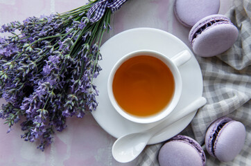 Cup of tea with macaroon dessert with lavender flavor