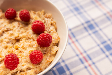 Oatmeal porridge with sweet raspberries. Selective focus.