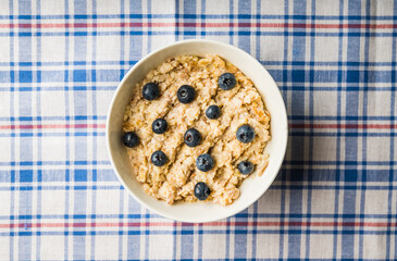 Oatmeal porridge with berries. Selective focus.