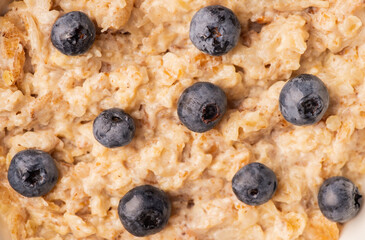 Oatmeal porridge with berries. Selective focus.