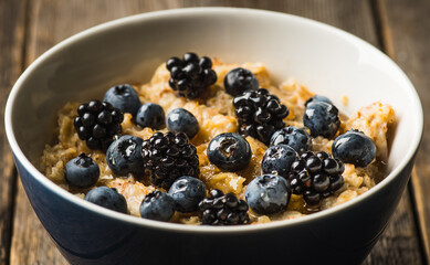 Oatmeal porridge with berries. Selective focus.