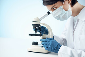 woman laboratory assistant medical mask microscope diagnostics biotechnology